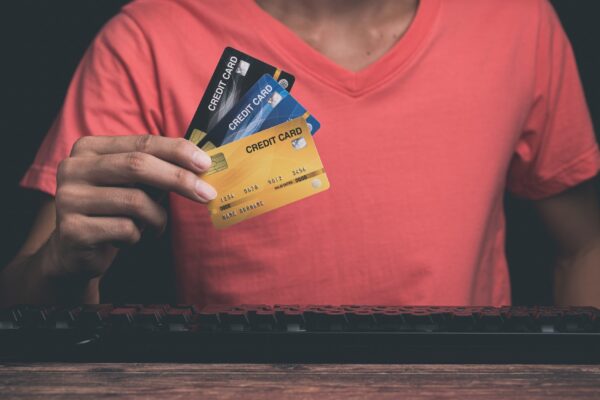 A man is using a credit card Through computer