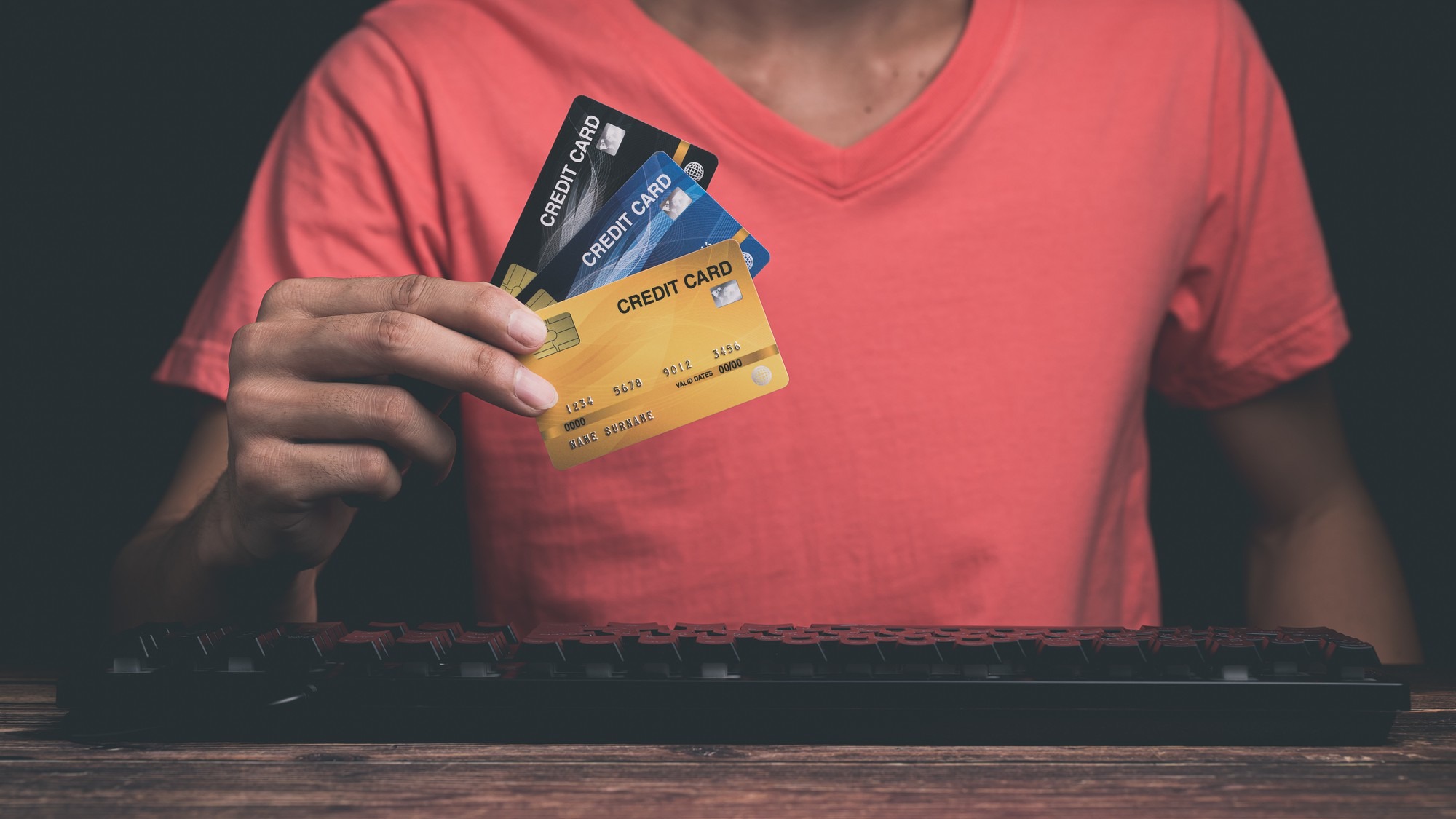 A man is using a credit card Through computer