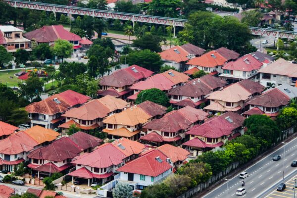 cars on road near houses during daytime