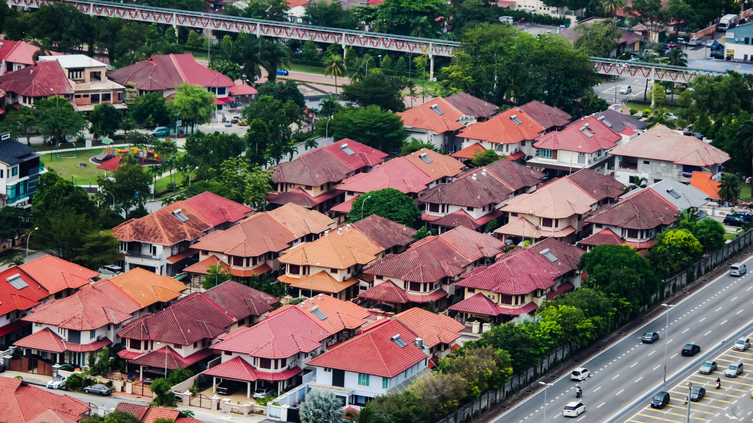cars on road near houses during daytime