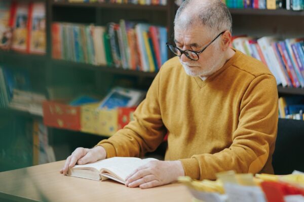 Surrounded by the literary wonders of the bookstore a nice old man with a distinguished beard and