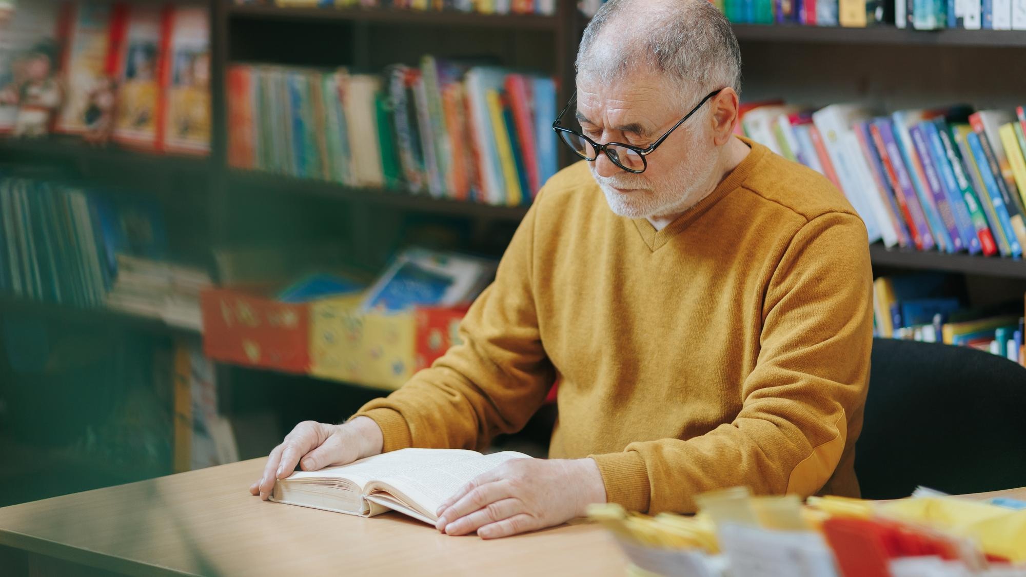 Surrounded by the literary wonders of the bookstore a nice old man with a distinguished beard and