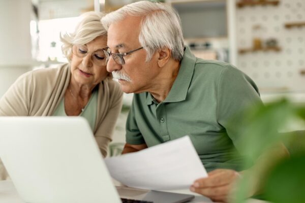 Senior couple analyzing their savings while going through home finances