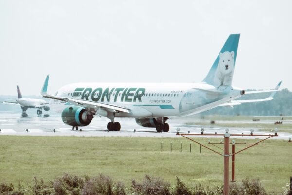 white passenger plane on green grass field during daytime