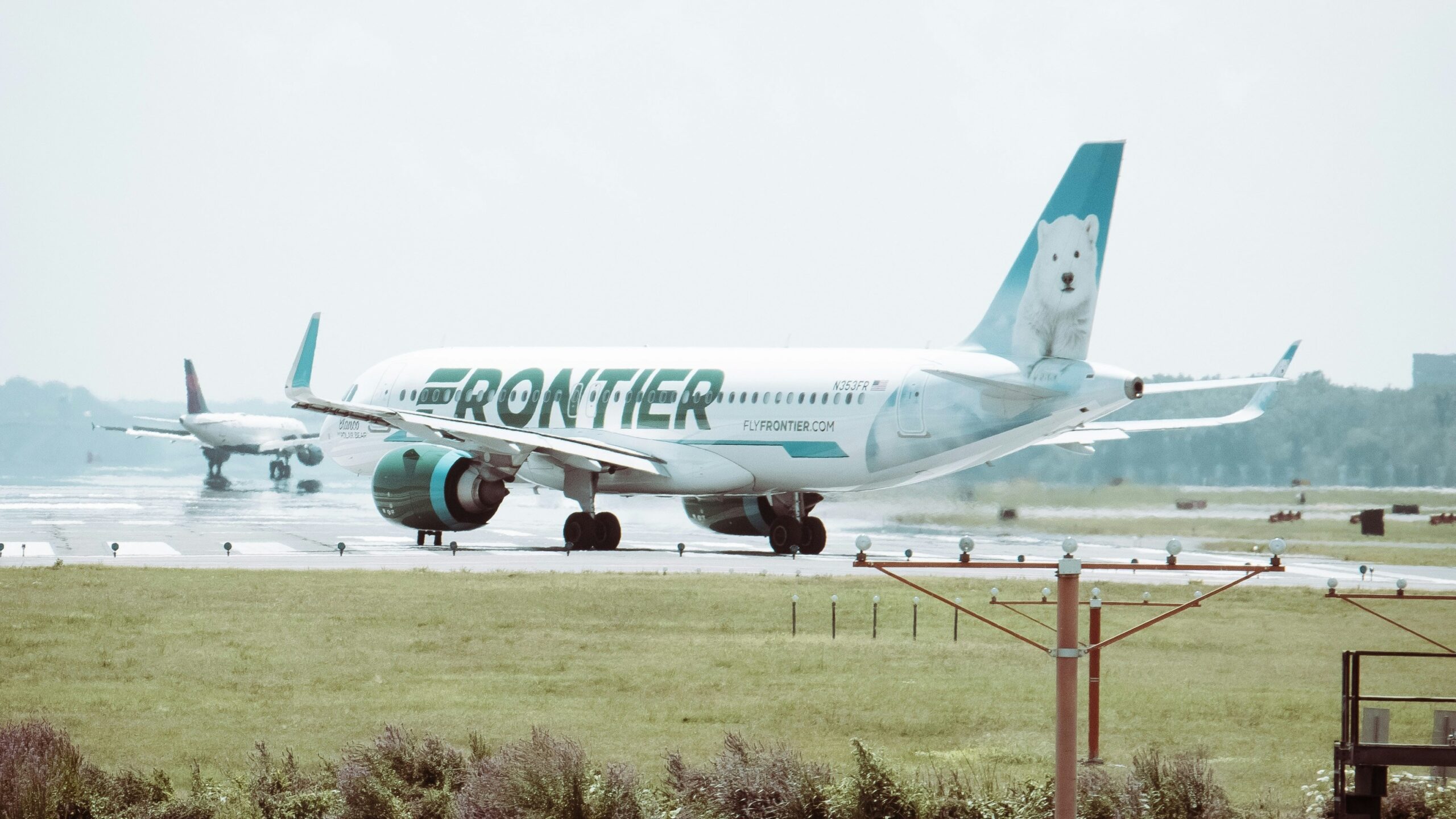 white passenger plane on green grass field during daytime