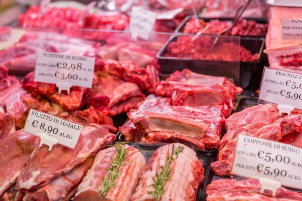 Meat department shelves with typical Italian raw meat inside grocery market in Italy
