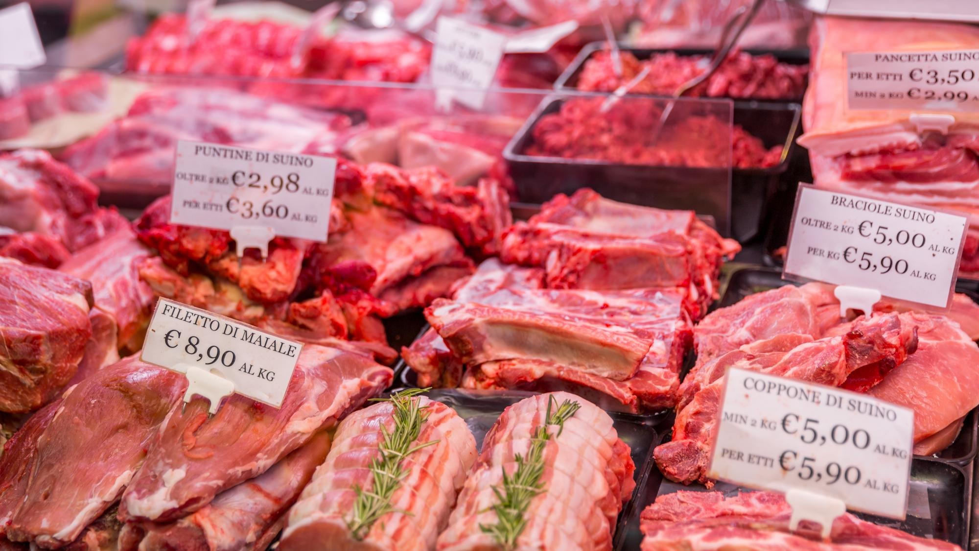 Meat department shelves with typical Italian raw meat inside grocery market in Italy