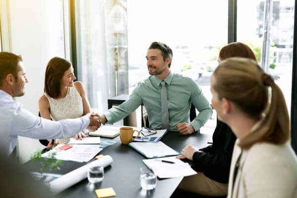 Handshake meeting and welcome with business people in boardroom of office for bonus or promotion Deal success or thank you with happy employee group shaking hands in workplace for agreement