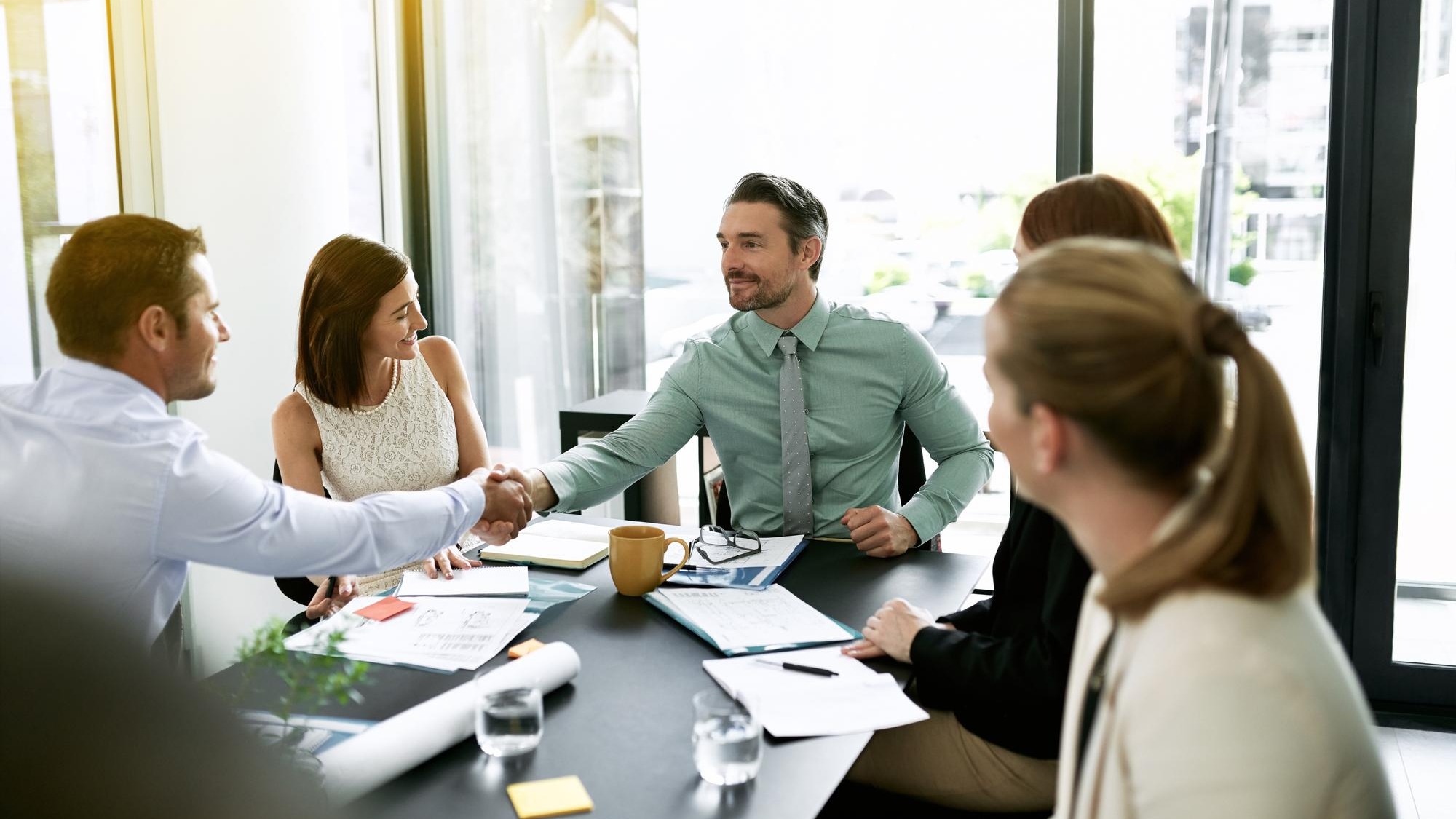 Handshake meeting and welcome with business people in boardroom of office for bonus or promotion Deal success or thank you with happy employee group shaking hands in workplace for agreement