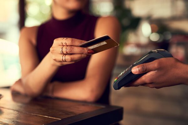 Swipe it off my cheque account Closeup shot of a woman paying using NFC technology in a cafe