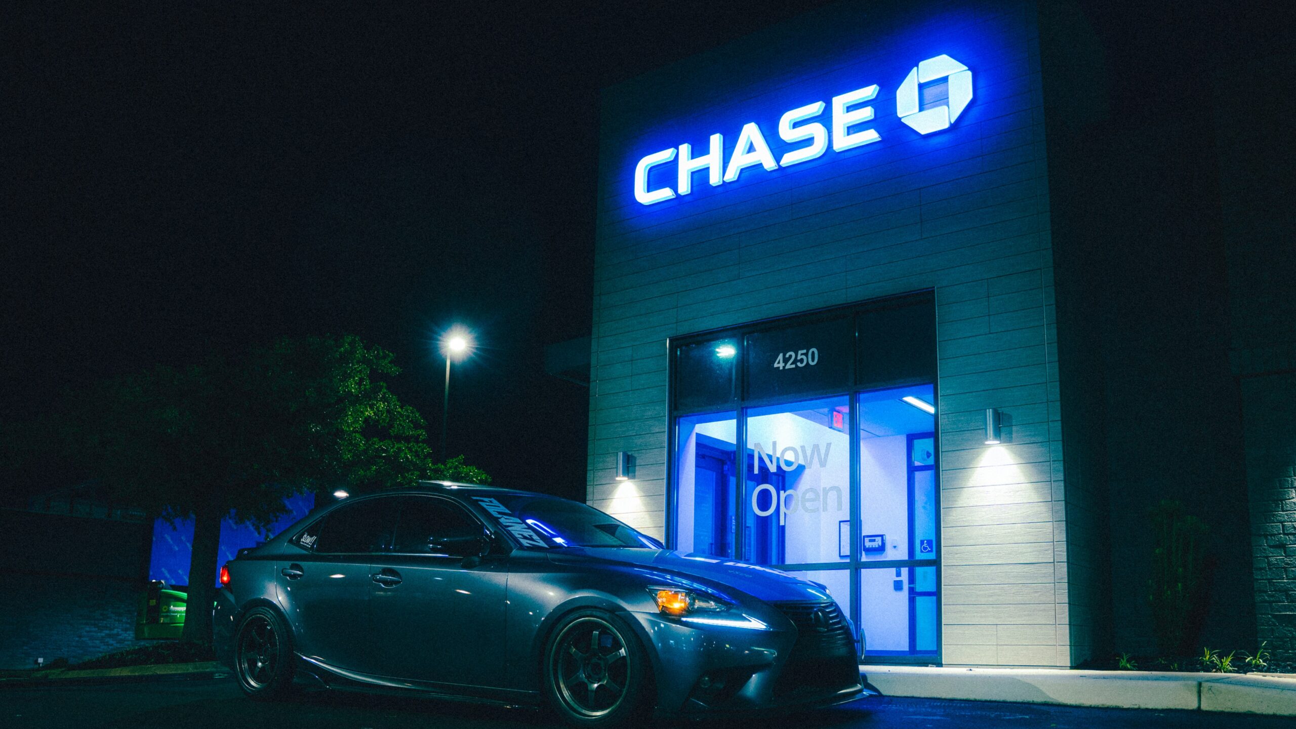 A car parks in front of a chase bank.