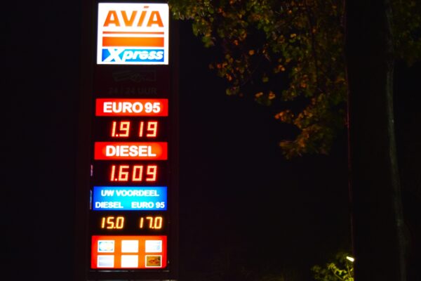 a gas station sign lit up at night