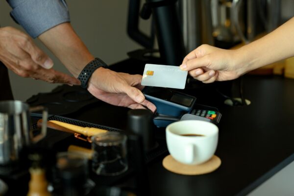 Unrecognizable customer making payment in coffee shop with credit card Financial transaction and technology concept