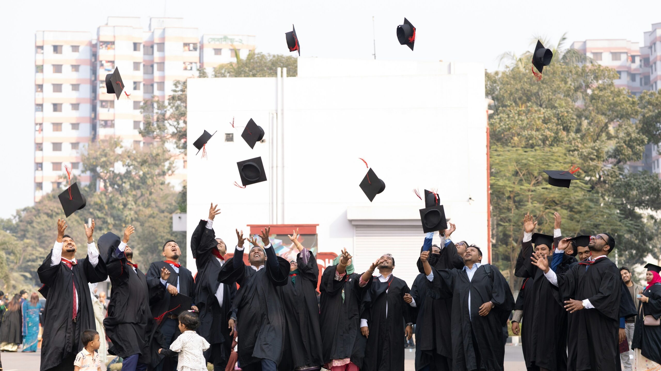 Graduates toss caps in the air celebrating