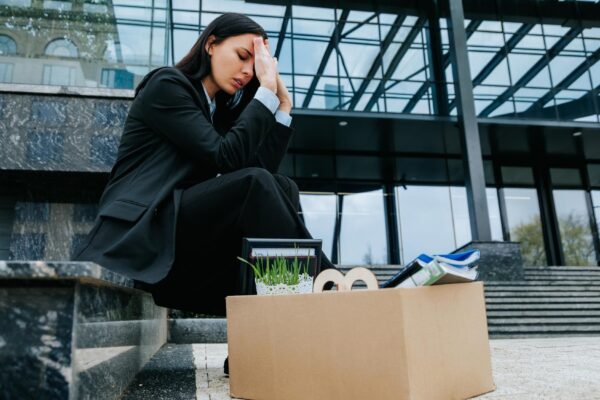 Sitting in silence after her job loss she contemplates the workless days ahead