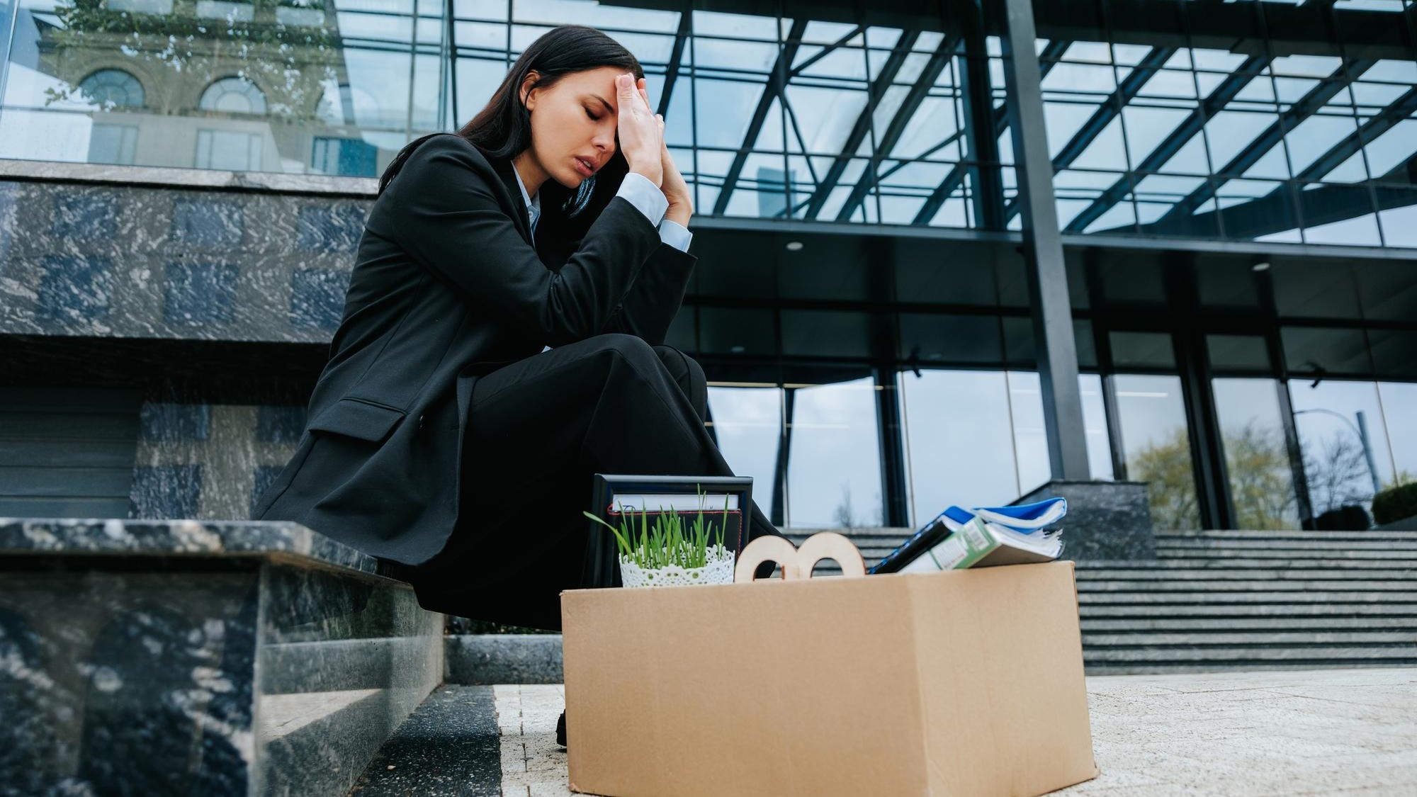 Sitting in silence after her job loss she contemplates the workless days ahead