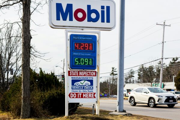 a mobil gas station sign next to a road