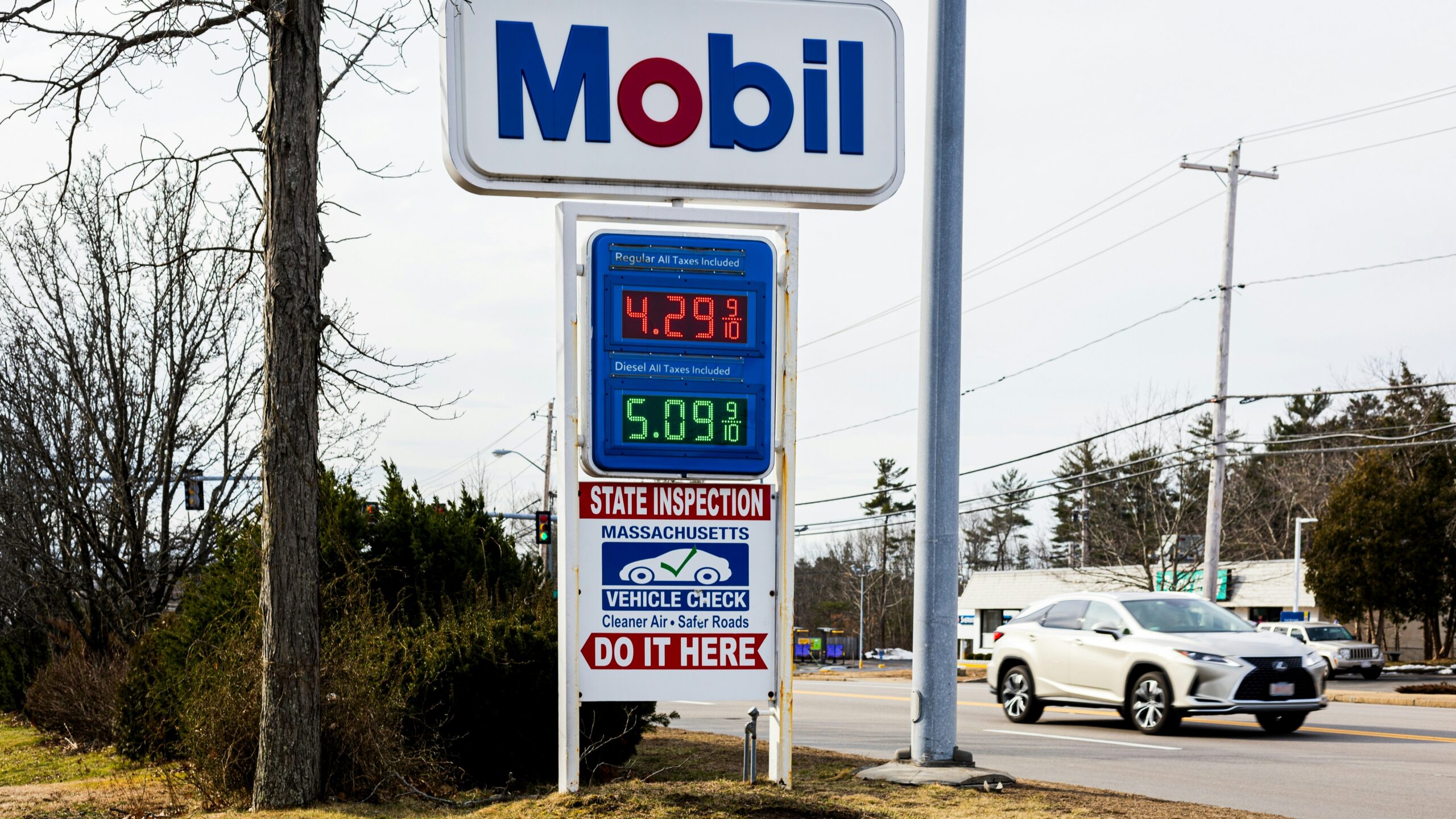 a mobil gas station sign next to a road