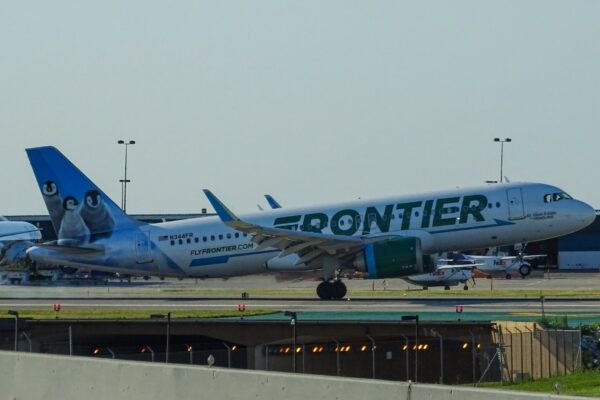 green and white Frontier airliner