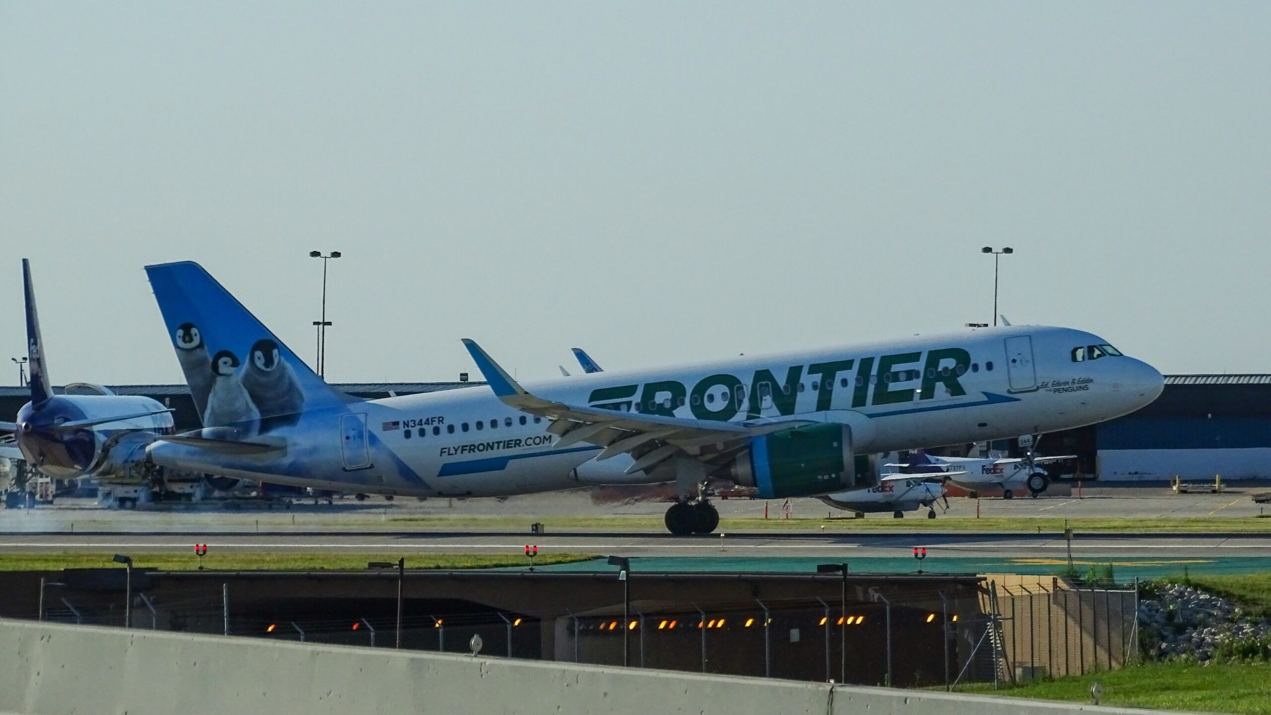 green and white Frontier airliner
