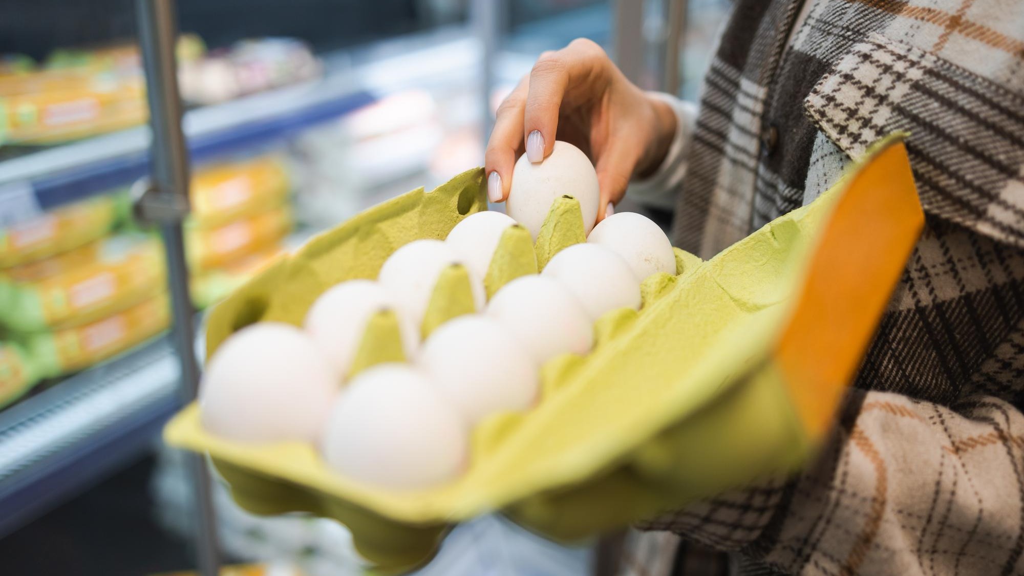 Girl holding a package of eggs in her hands