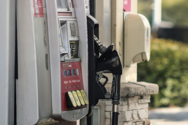 a gas pump next to a brick wall