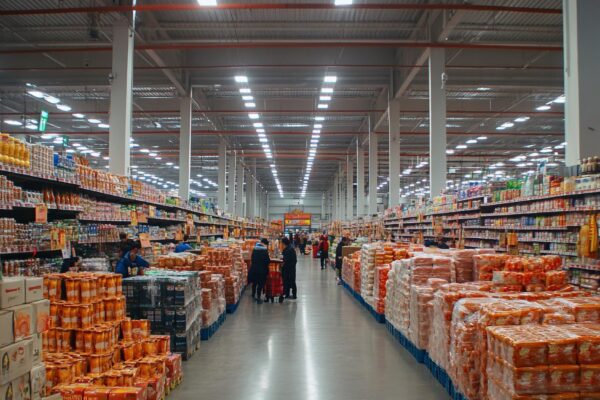 Bright and Spacious Warehouse Supermarket with Customers Shopping for Gifts