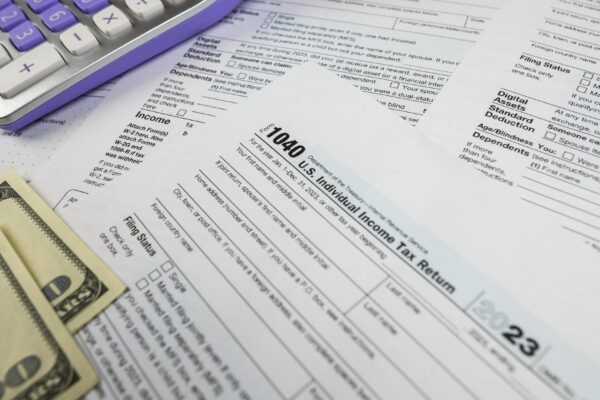 Tax form 1040 with calculator and dollars