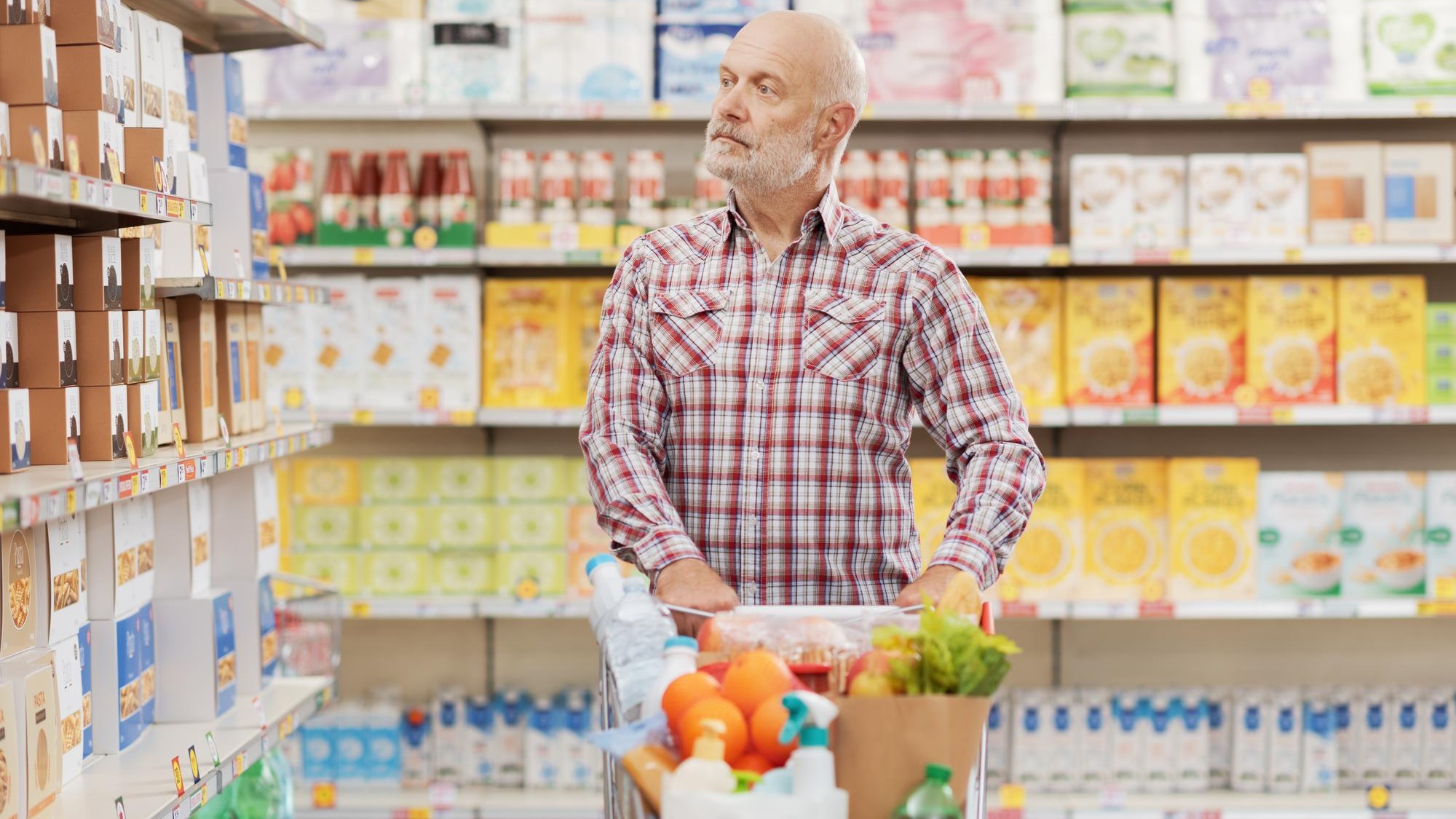 Mature man buying groceries at the supermarket