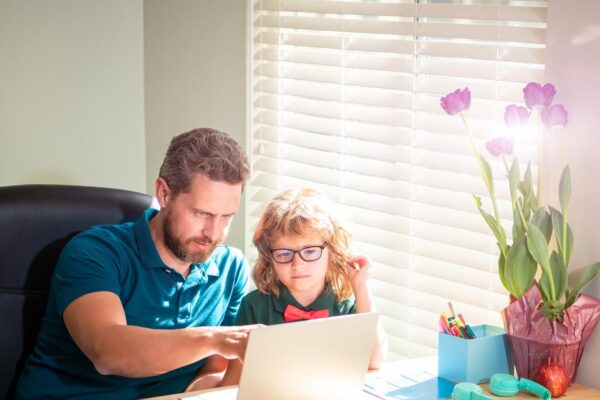 Banner of teacher and pupil school boy with laptop at home happy daddy helping his school son kid