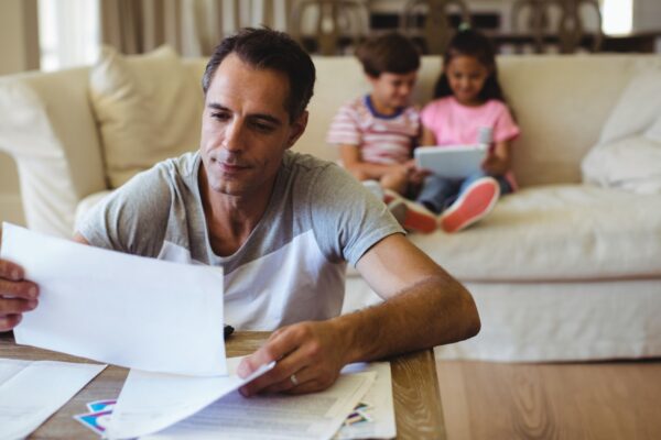 Man holding a bill in living room