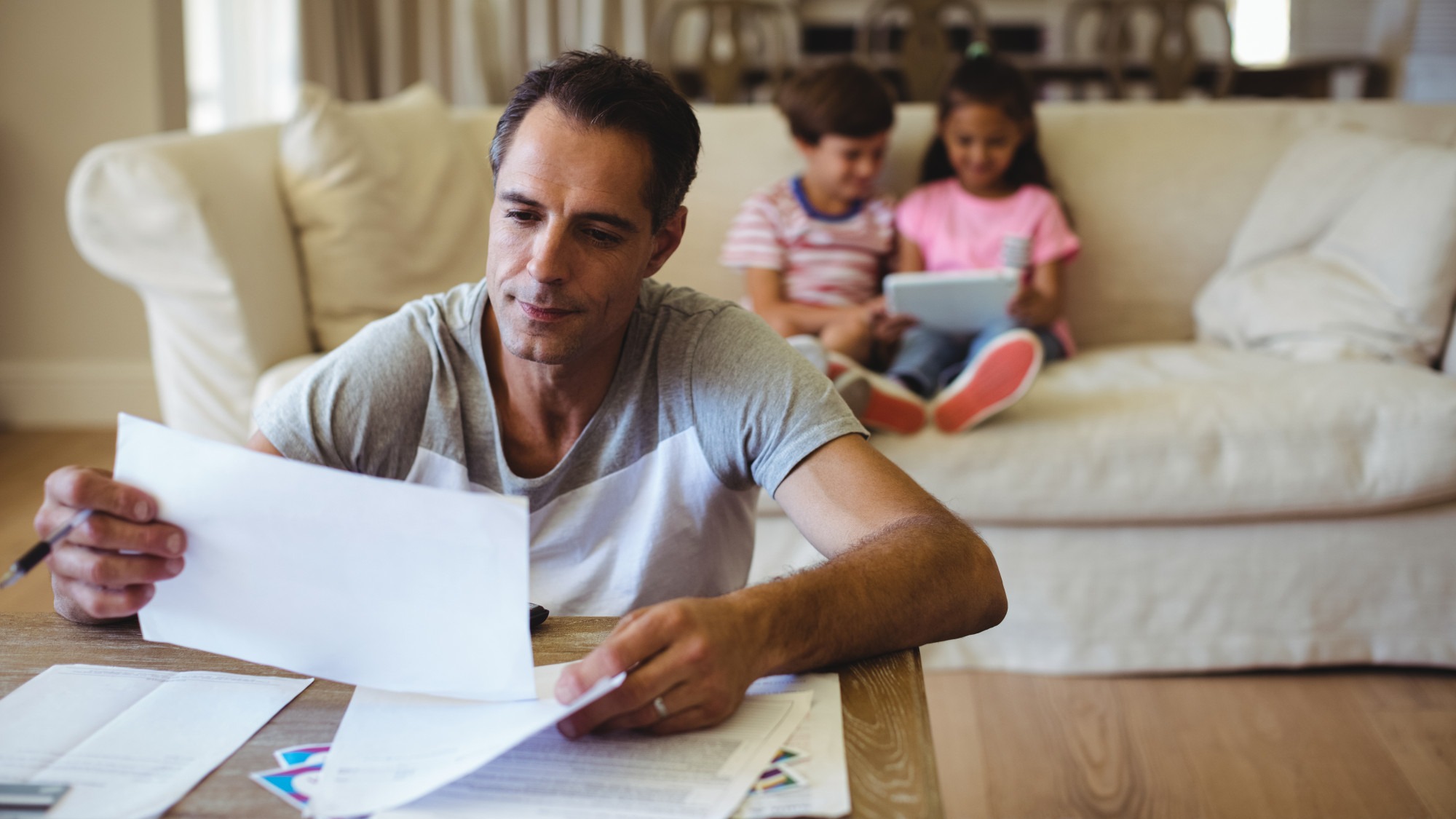 Man holding a bill in living room