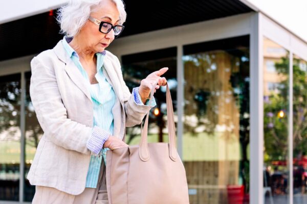 stylish mature woman looking in her bag