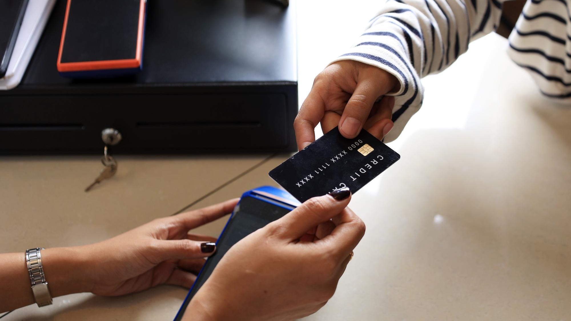 Close Up Female Customer Paying with Black Credit Card