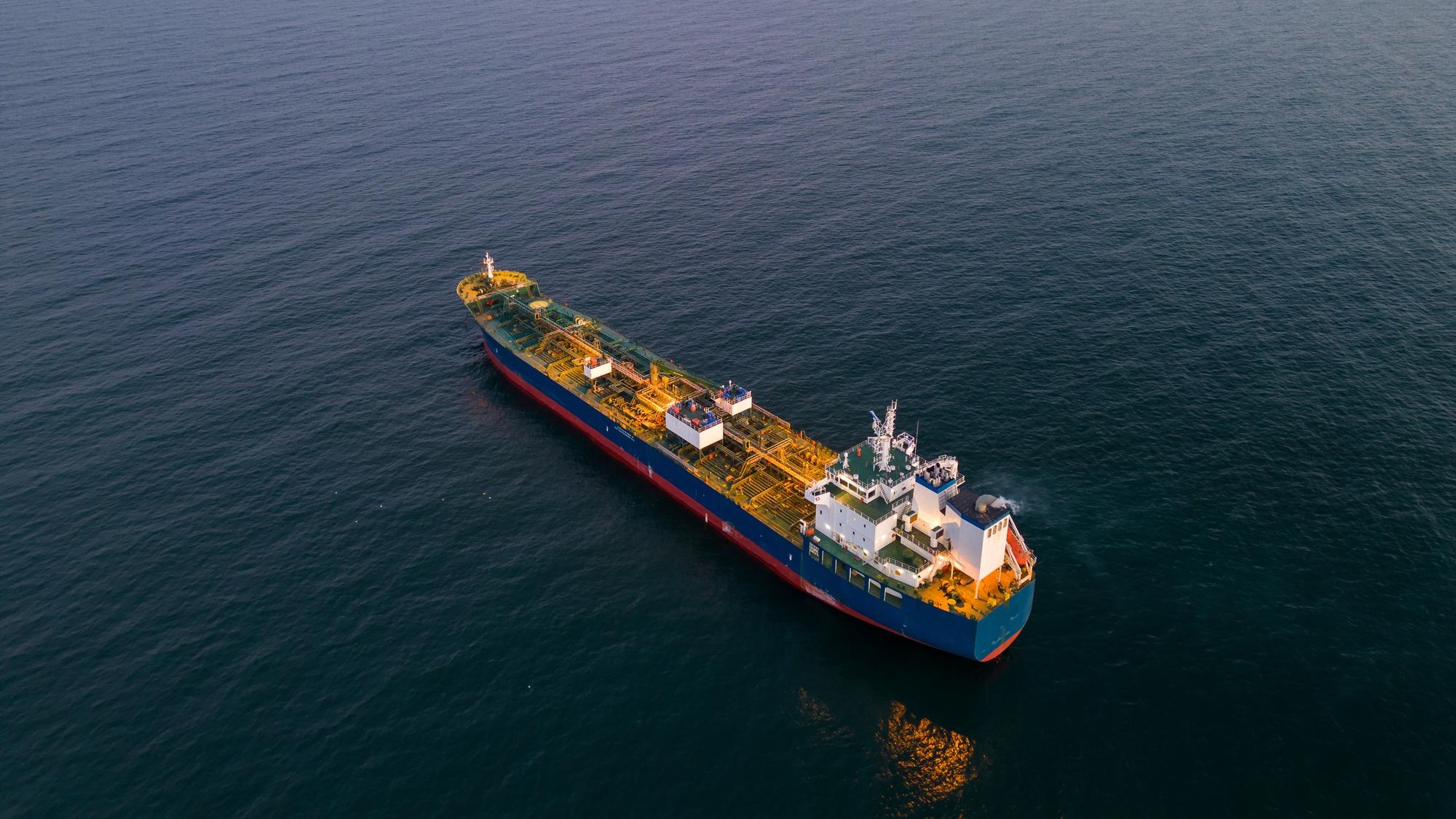 Aerial view oil ship tanker carrier oil on the sea at sunset