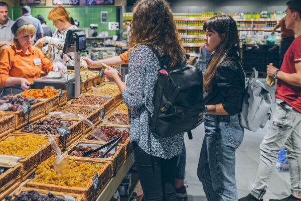 LVIV UKRAINE September 8 2018 people buying dried fruit in grocery store