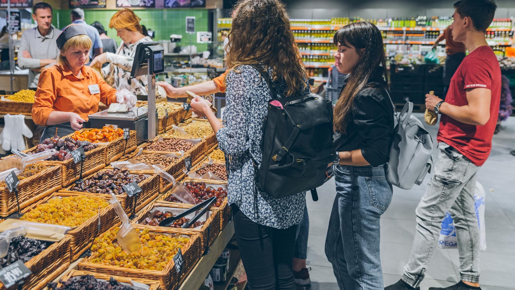 LVIV UKRAINE September 8 2018 people buying dried fruit in grocery store
