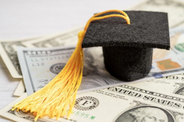 Graduation gap hat on US dollar banknotes money Education study fee learning teach concept