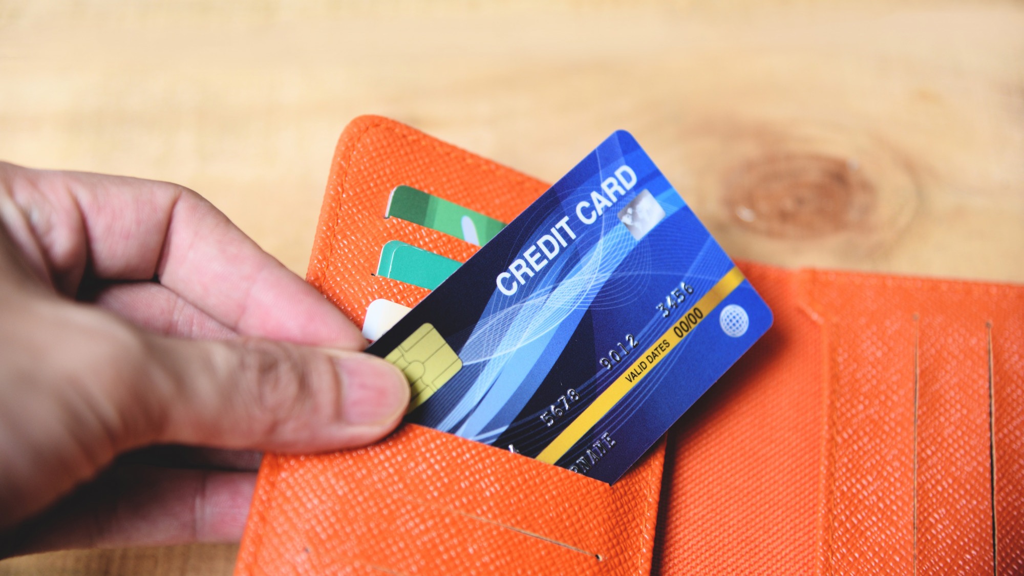 Credit card in wallet with hand