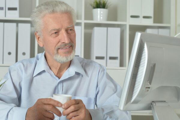 Mature businessman working on computer in office