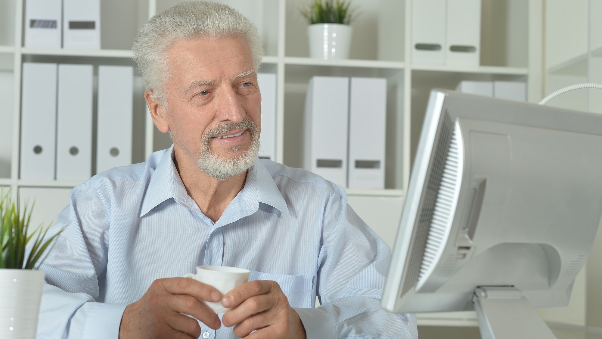 Mature businessman working on computer in office