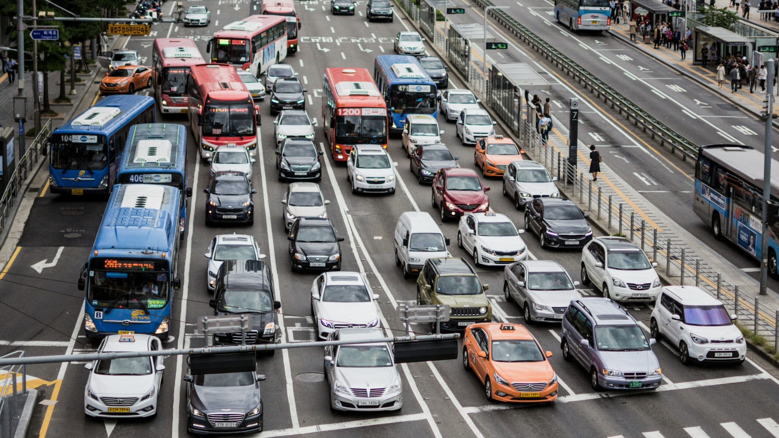 cars on road surrounded by buildings during daytime