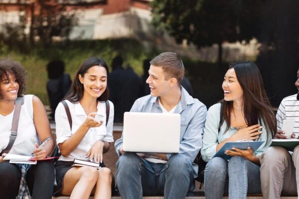 Campus Life Cheerful college students resting outdoors between classes