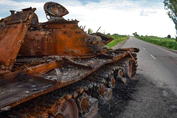 a rusted out truck on a road