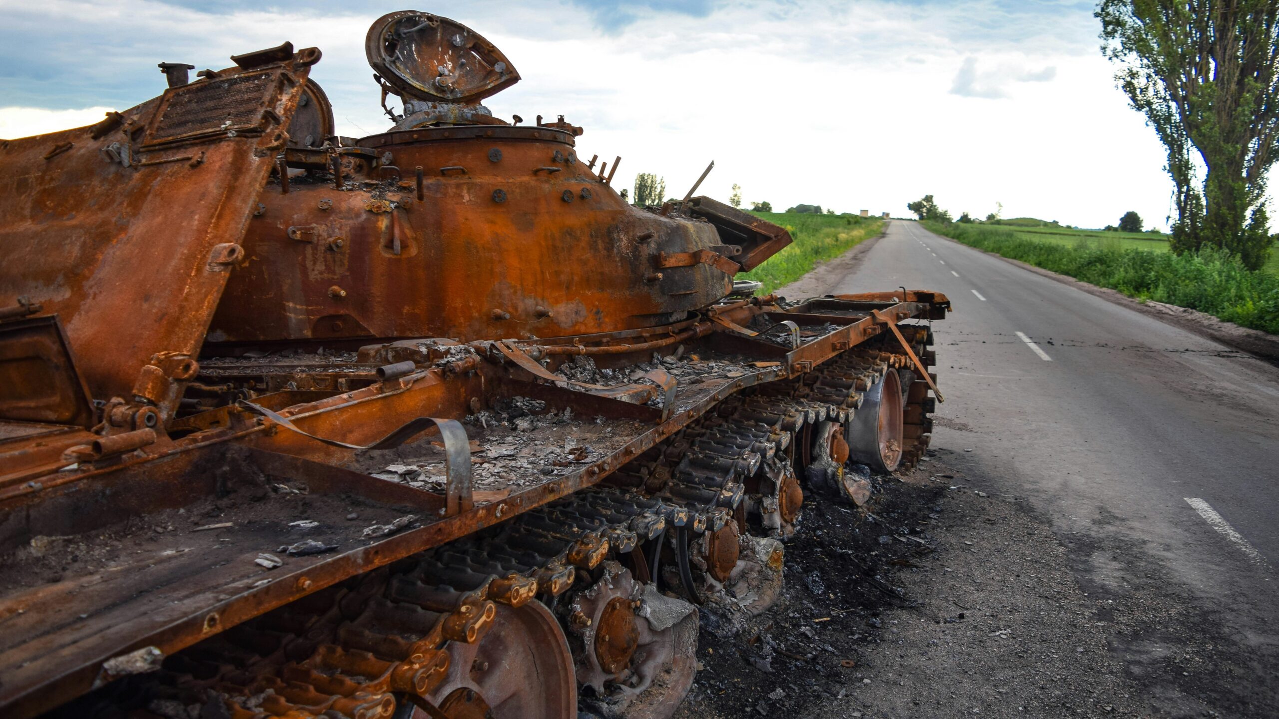 a rusted out truck on a road