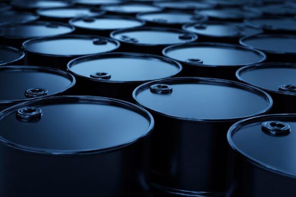 Oil barrels standing in rows representing the petroleum industry global energy supply production and storage concepts