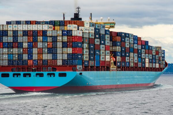 blue and red cargo ship on sea during daytime