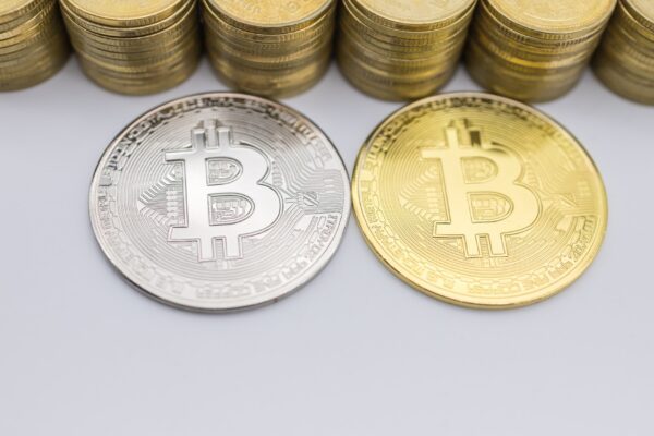 Money, Finance, E-Commerce and cryptocurrency . Close up of silver and gold Bitcoin coin with stack.