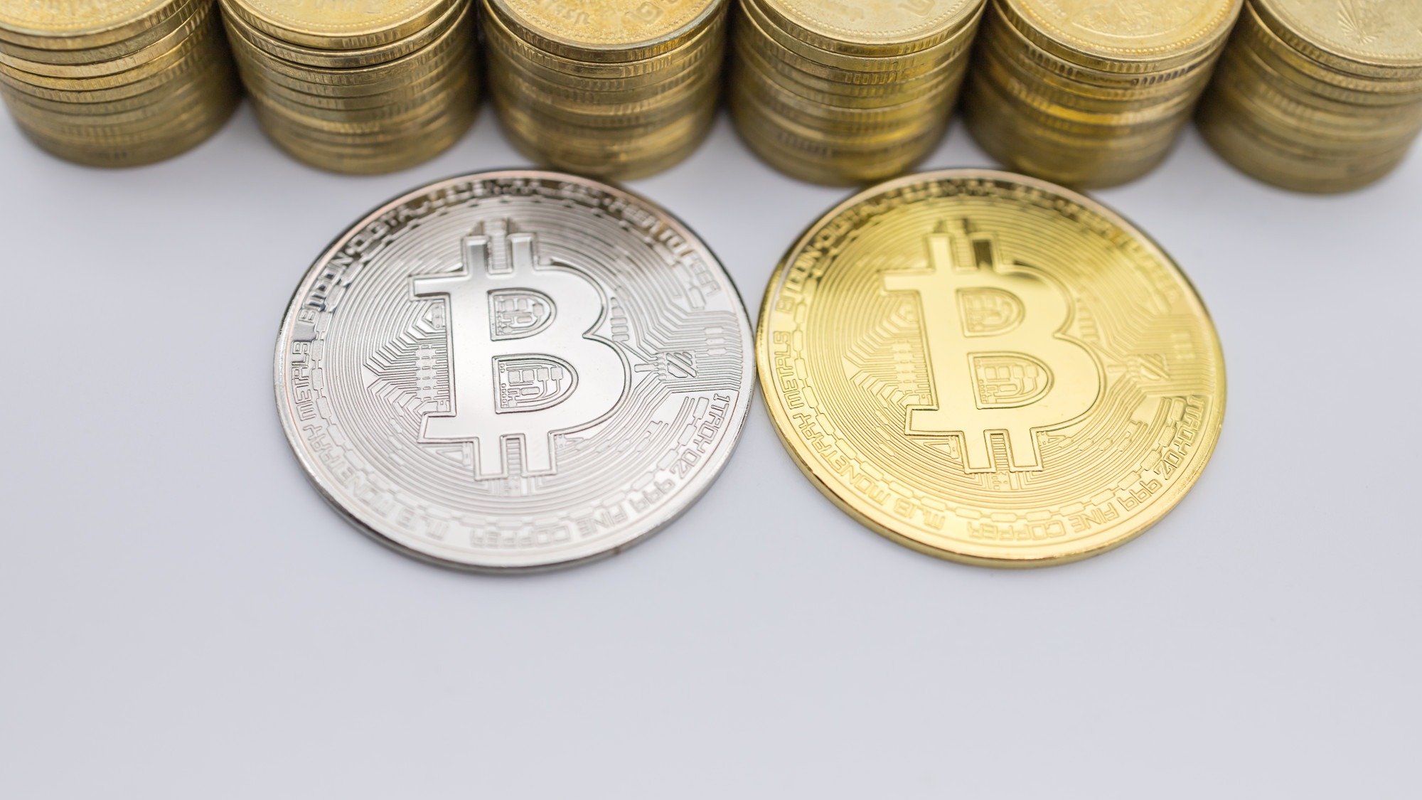 Money, Finance, E-Commerce and cryptocurrency . Close up of silver and gold Bitcoin coin with stack.