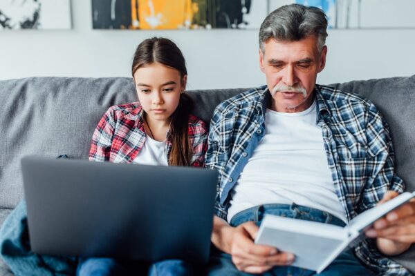 Family time! Grandfather helping granddaughter with homework.